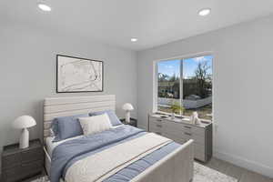 Bedroom with recessed lighting and light carpet