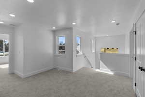 Carpeted spare room featuring recessed lighting