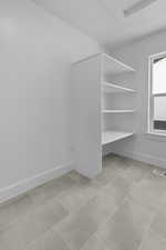 Mudroom featuring tile patterned flooring and attic access