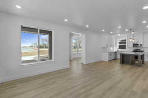 Unfurnished living room featuring recessed lighting and light wood finished floors