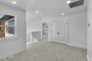 Carpeted spare room featuring recessed lighting and baseboards