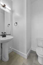 Half bath with tile patterned floors