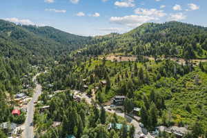 Aerial view of property and surrounding area with a mountainous background