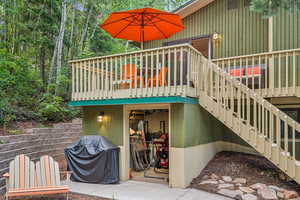 Exterior space with a wooden deck, stairway, and area for grilling