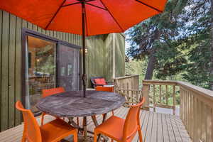 Wooden terrace featuring outdoor dining area