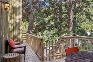Wooden deck featuring outdoor dining area