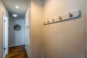 Hallway has a bank of Cabinets for Storage and Beautiful Hardwood Floors!