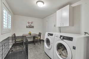 Laundry area featuring cabinet space and washer and dryer