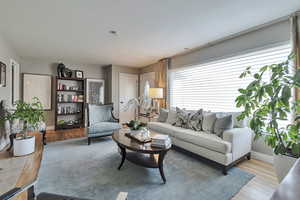 Living area featuring light wood-type flooring and baseboards