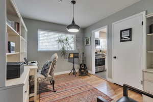Home office with light wood-style floors and baseboards