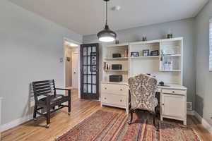 Office area featuring light wood-style floors and baseboards