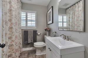 Full bathroom with toilet and vanity