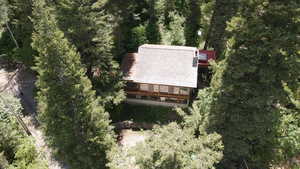 View of subject property featuring a heavily wooded area