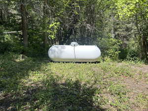 Exterior view of gas tank and a heavily wooded area