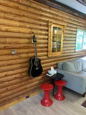 Living area with wood finished floors and rustic walls