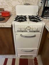 Kitchen view of white gas stove and light countertops