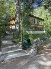 View of front of home featuring stairs and a chimney