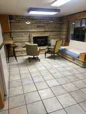 Living area featuring light tile patterned floors and a fireplace