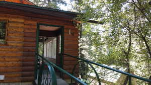 View of exterior entry with log veneer siding