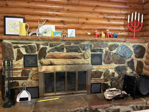 Detailed view of a stone fireplace and rustic walls