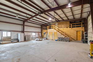 Inside of Shop. Half Bath under stairs and 2nd bedroom on mezzanine.