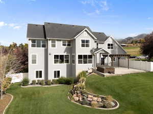 Rear view of property featuring a fenced backyard, a pergola, and a patio area