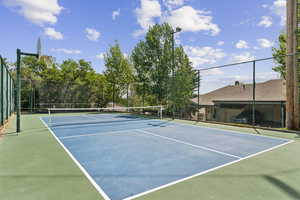 View of tennis court with community basketball court