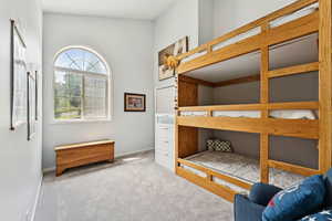 Carpeted bedroom featuring baseboards