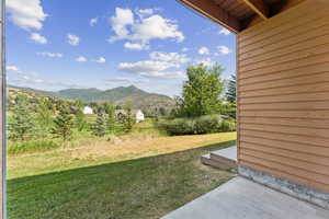 View of grassy yard featuring a mountain view