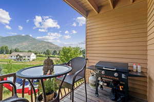 Balcony featuring a mountain view and grilling area