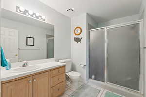 Bathroom featuring vanity, tile patterned floors, and a stall shower