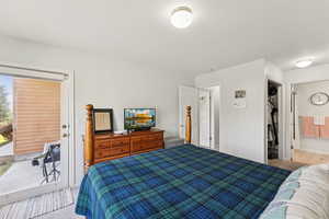 Bedroom featuring access to outside and connected bathroom