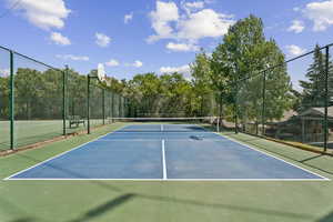 View of tennis court with community basketball court