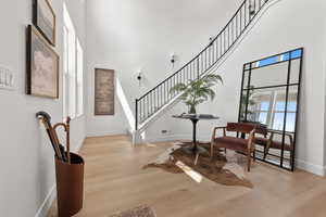 Foyer entrance with a towering 19 ft ceiling and curved staircase.