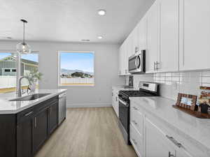 Kitchen featuring extra wide area between island and range.