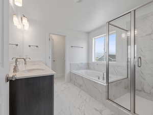 Primary bathroom with soaker tub, Euro glass shower and double sinks.