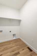 Laundry area featuring washer hookup, hookup for an electric dryer, and light wood-style flooring