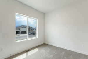 Carpeted empty room with baseboards