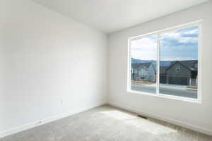 Unfurnished room with carpet floors and a mountain view