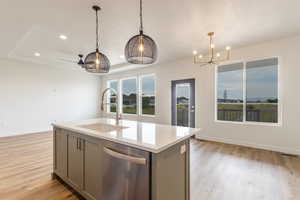 Kitchen featuring gray cabinetry, dishwasher, a chandelier, recessed lighting, and light wood-style floors