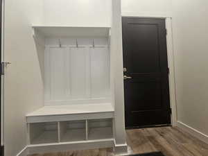 Mudroom with wood finished floors and baseboards