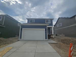 Traditional home featuring driveway and an attached garage