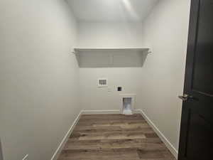 Laundry area featuring dark wood-style flooring, hookup for a washing machine, and electric dryer hookup