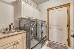 Washroom with cabinet space and separate washer and dryer