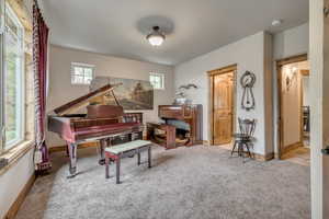 Living area with carpet and baseboards