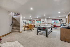 Game room with light colored carpet and recessed lighting