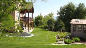 View of green lawn featuring a patio