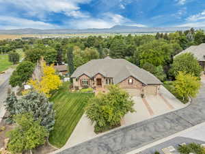 Aerial view of property and surrounding area with a mountain backdrop