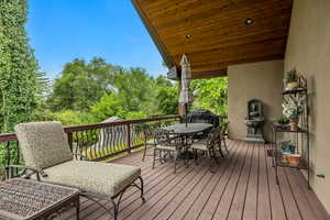 Wooden terrace featuring outdoor dining area