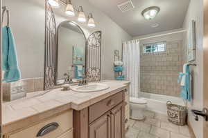 Full bathroom featuring vanity, tile patterned floors, and shower / bath combo